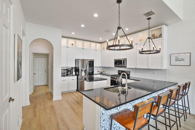 138 NW Magnolia Lakes Blvd, Port Saint Lucie, FL 34986 - kitchen featuring appliances with stainless steel finishes, a peninsula, light wood finished floors, a sink, and recessed lighting