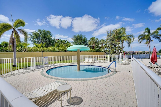 138 NW Magnolia Lakes Blvd, Port Saint Lucie, FL 34986 - community pool with fence and a patio area