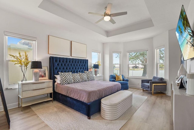 138 NW Magnolia Lakes Blvd, Port Saint Lucie, FL 34986 - bedroom with a raised ceiling, light wood-type flooring, baseboards, and ceiling fan
