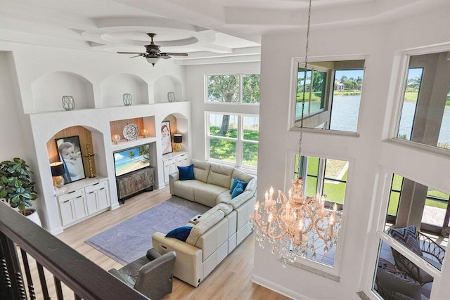 138 NW Magnolia Lakes Blvd, Port Saint Lucie, FL 34986 - living room with light wood-style floors, a ceiling fan, beamed ceiling, coffered ceiling, and a towering ceiling