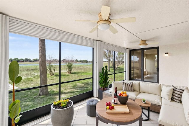 sunroom featuring a water view, a ceiling fan, and an outdoor hangout area