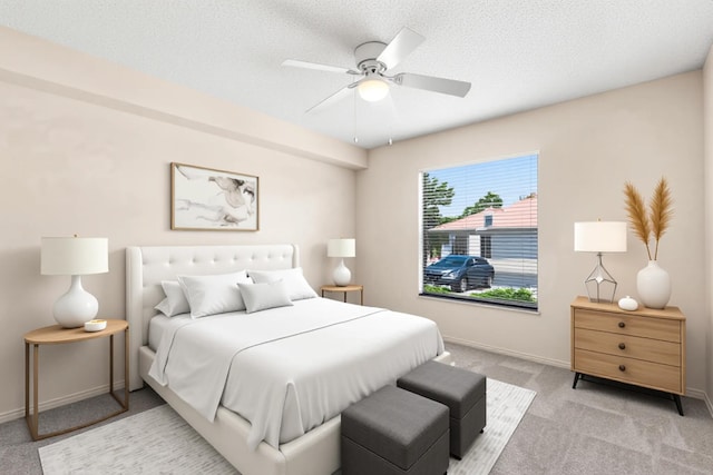 carpeted bedroom featuring baseboards and ceiling fan