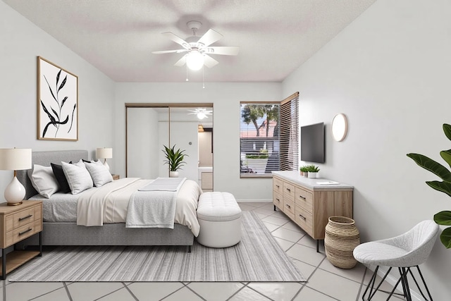 bedroom with light tile patterned floors, a closet, baseboards, and ceiling fan