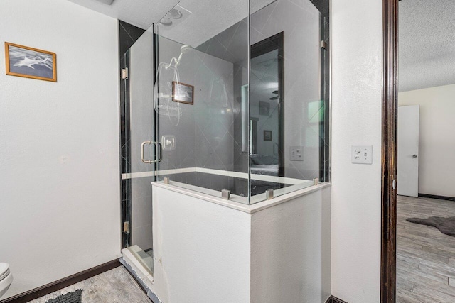 4901 129th Ave N, The Acreage, FL 33411 - full bathroom with a shower stall, a textured ceiling, wood finished floors, and toilet