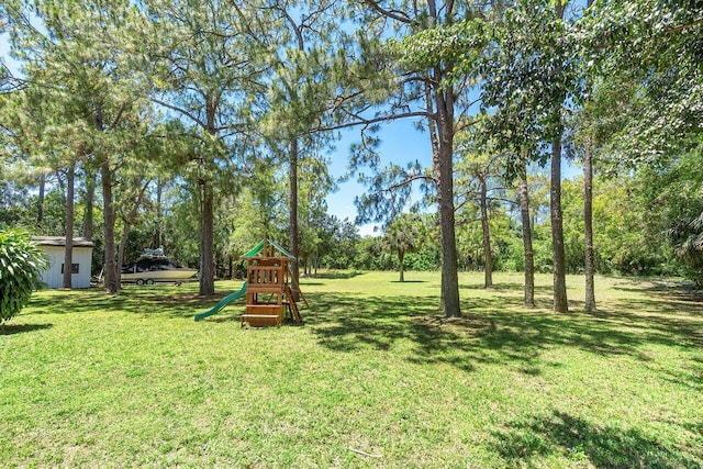 4901 129th Ave N, The Acreage, FL 33411 - view of green lawn featuring a playground and view of scattered trees
