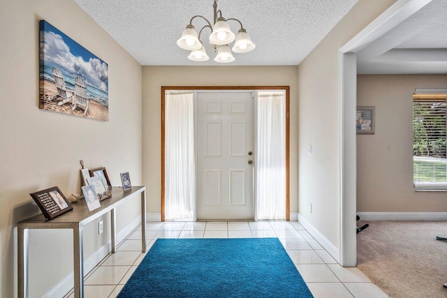 4901 129th Ave N, The Acreage, FL 33411 - foyer featuring a chandelier, tile patterned flooring, baseboards, and a textured ceiling
