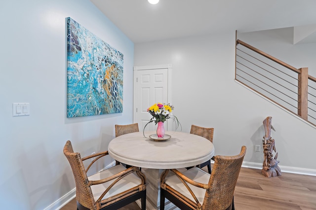 1310 S Jeaga Dr, Jupiter, FL 33458 - dining room with light wood-style floors, baseboards, and stairs