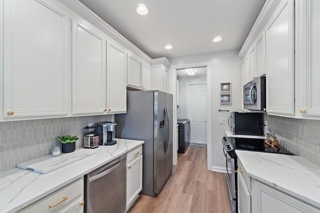 1310 S Jeaga Dr, Jupiter, FL 33458 - kitchen featuring appliances with stainless steel finishes, decorative backsplash, white cabinets, light wood-style floors, and light stone countertops