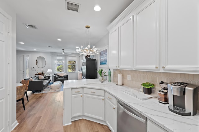 1310 S Jeaga Dr, Jupiter, FL 33458 - kitchen with dishwasher, white cabinets, a peninsula, recessed lighting, and light wood-type flooring
