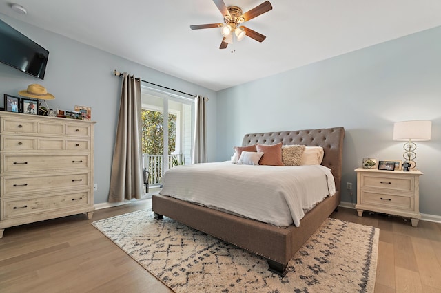 1310 S Jeaga Dr, Jupiter, FL 33458 - bedroom featuring access to outside, wood finished floors, a ceiling fan, and baseboards