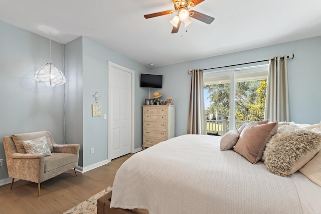 1310 S Jeaga Dr, Jupiter, FL 33458 - bedroom with wood finished floors, baseboards, and ceiling fan