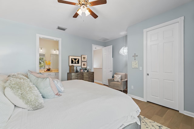 1310 S Jeaga Dr, Jupiter, FL 33458 - bedroom with wood finished floors, baseboards, ceiling fan, and ensuite bathroom