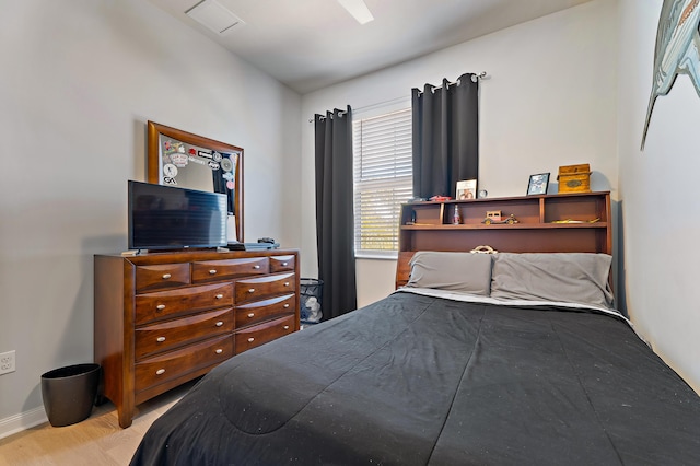 1310 S Jeaga Dr, Jupiter, FL 33458 - bedroom with baseboards, wood finished floors, and a ceiling fan