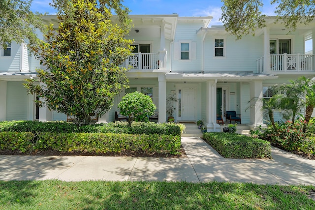 1310 S Jeaga Dr, Jupiter, FL 33458 - view of front facade featuring a porch and a balcony