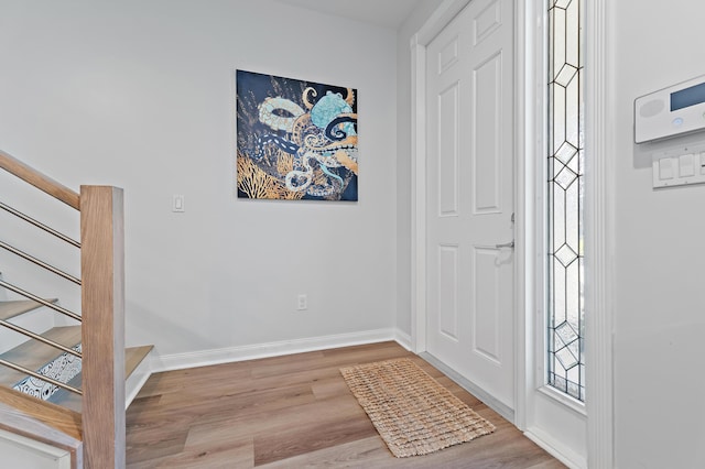 1310 S Jeaga Dr, Jupiter, FL 33458 - entrance foyer featuring stairway, wood finished floors, and baseboards