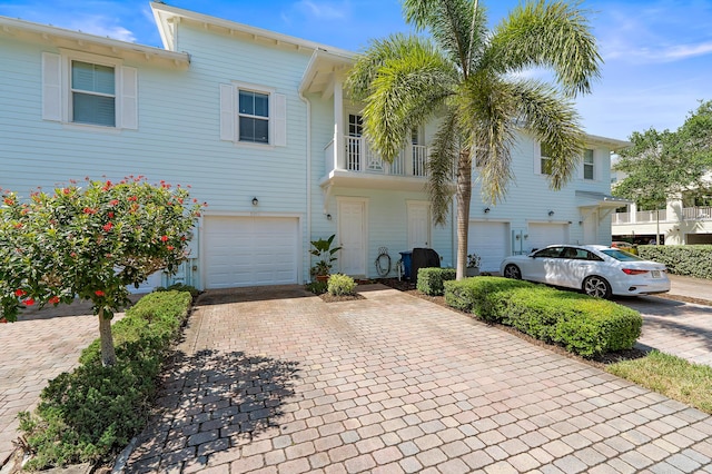 1310 S Jeaga Dr, Jupiter, FL 33458 - townhome / multi-family property featuring an attached garage and decorative driveway
