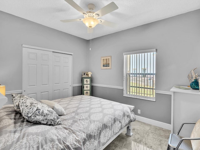 6382 NW 38th Dr, Coral Springs, FL 33067 - bedroom with a closet, a textured ceiling, and ceiling fan