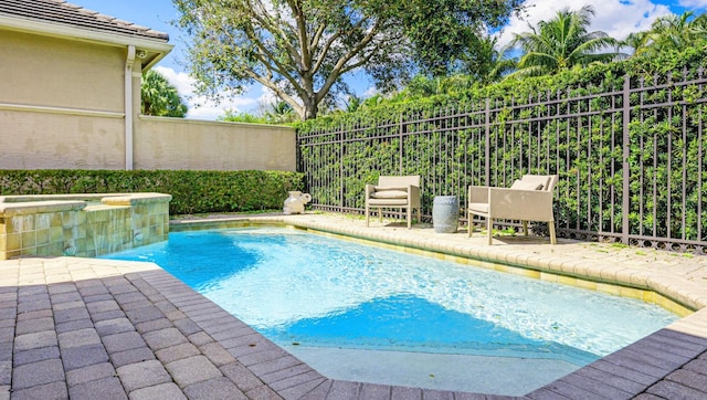 2068 Wightman Dr, Wellington, FL 33414 - view of swimming pool featuring fence, a pool with connected hot tub, and a patio