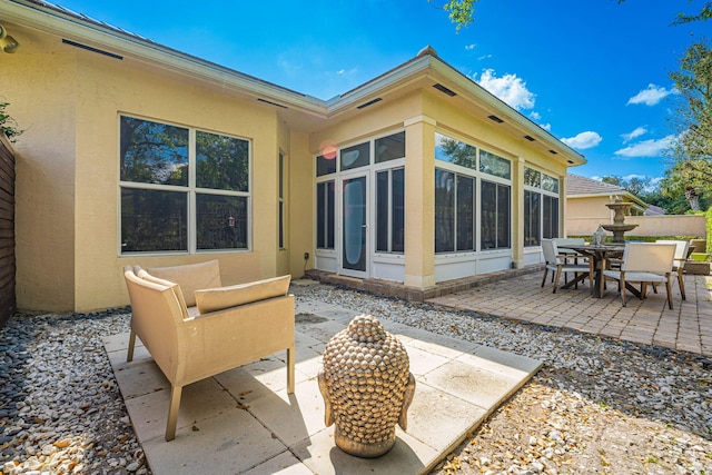 2068 Wightman Dr, Wellington, FL 33414 - view of patio featuring a sunroom and outdoor dining space