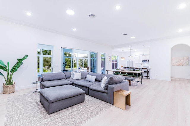 2068 Wightman Dr, Wellington, FL 33414 - living room featuring arched walkways, recessed lighting, baseboards, and light wood-style floors
