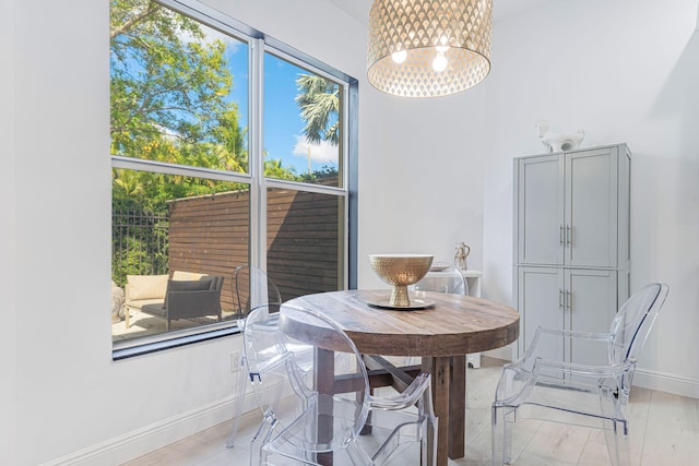 2068 Wightman Dr, Wellington, FL 33414 - dining area with baseboards, a chandelier, and light wood-type flooring