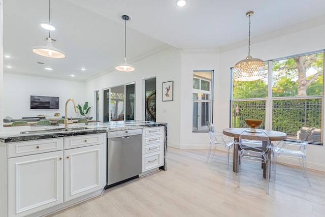 2068 Wightman Dr, Wellington, FL 33414 - kitchen with stainless steel dishwasher, a sink, crown molding, dark stone countertops, and light wood-style floors