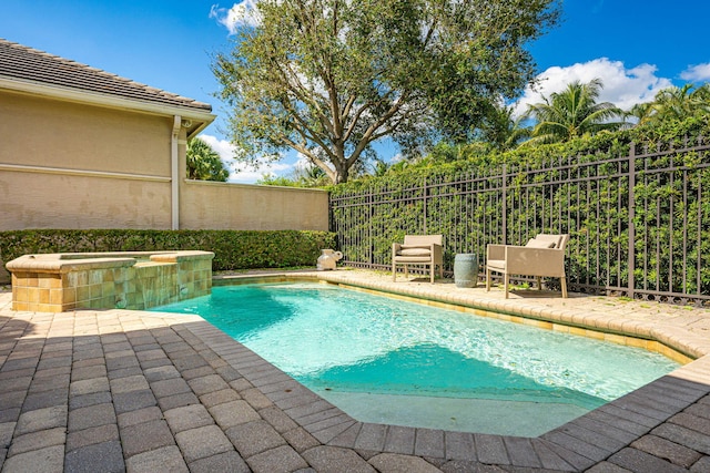 2068 Wightman Dr, Wellington, FL 33414 - view of swimming pool with fence, a patio area, and a pool with connected hot tub