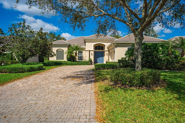 2068 Wightman Dr, Wellington, FL 33414 - mediterranean / spanish-style house with stucco siding, decorative driveway, and a tile roof