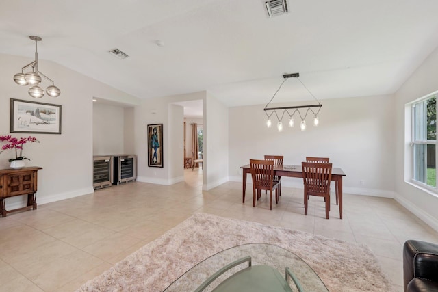 6085 Elmwood Dr, Boca Raton, FL 33433 - dining area featuring beverage cooler, light tile patterned flooring, lofted ceiling, and baseboards