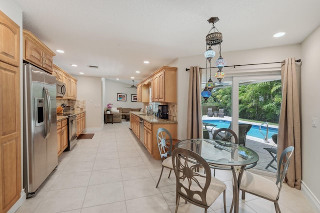 6085 Elmwood Dr, Boca Raton, FL 33433 - kitchen with stainless steel appliances, a sink, decorative backsplash, light stone counters, and recessed lighting