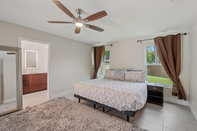 6085 Elmwood Dr, Boca Raton, FL 33433 - bedroom with a sink, baseboards, light tile patterned floors, connected bathroom, and ceiling fan