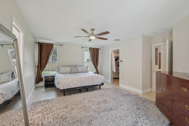 6085 Elmwood Dr, Boca Raton, FL 33433 - bedroom with light tile patterned floors, baseboards, ceiling fan, and a spacious closet