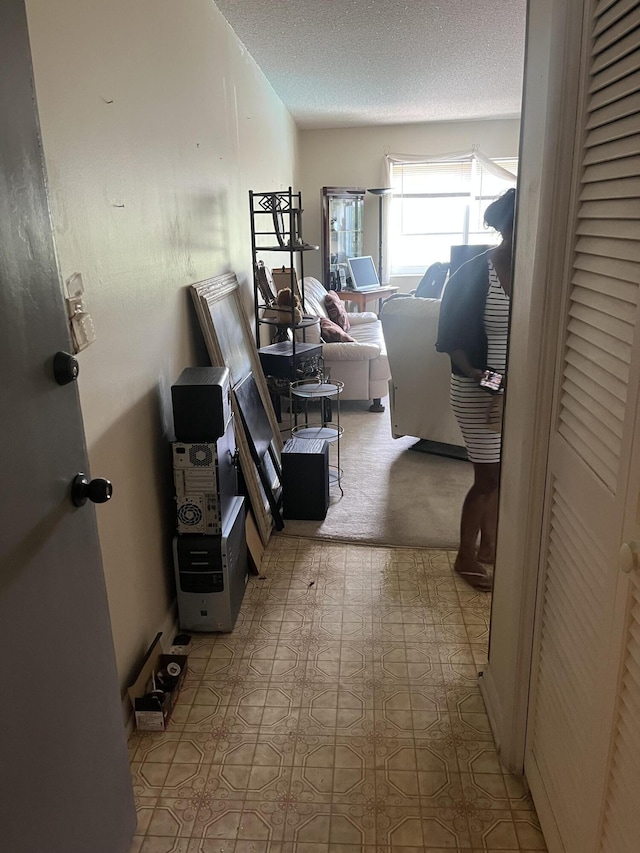659 W Oakland Park Blvd Unit 206C, Oakland Park, FL 33311 - hallway with a textured ceiling and light flooring