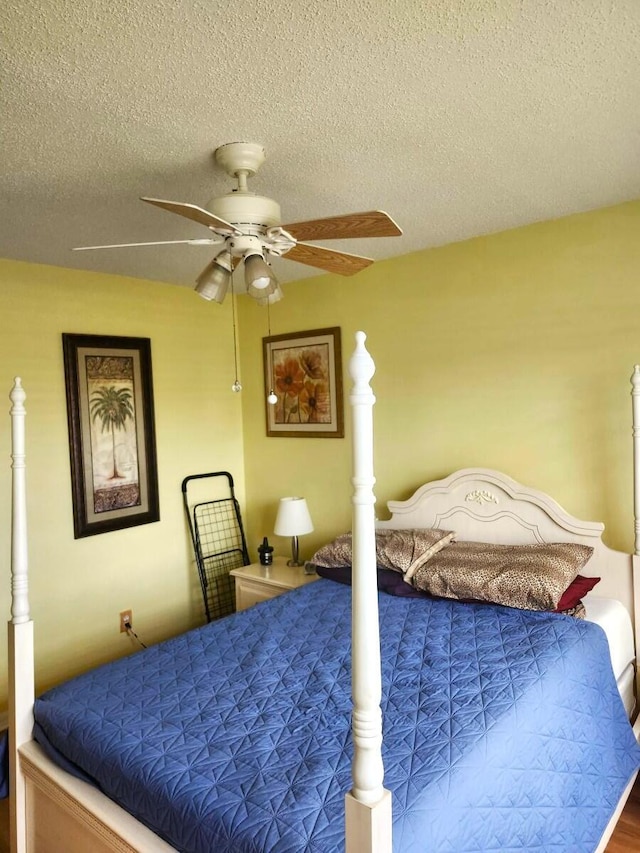 5794 Moss Ct Unit 7, Fort Pierce, FL 34982 - bedroom with a textured ceiling, ceiling fan, and wood finished floors