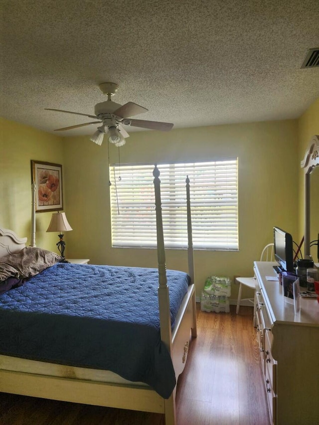 5794 Moss Ct Unit 7, Fort Pierce, FL 34982 - bedroom featuring a textured ceiling, ceiling fan, and wood finished floors