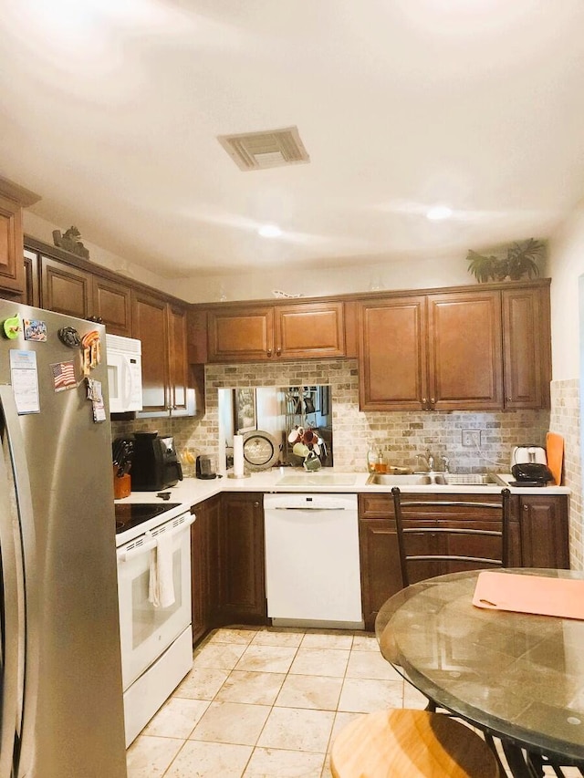 5794 Moss Ct Unit 7, Fort Pierce, FL 34982 - kitchen featuring white appliances, light countertops, a sink, and backsplash