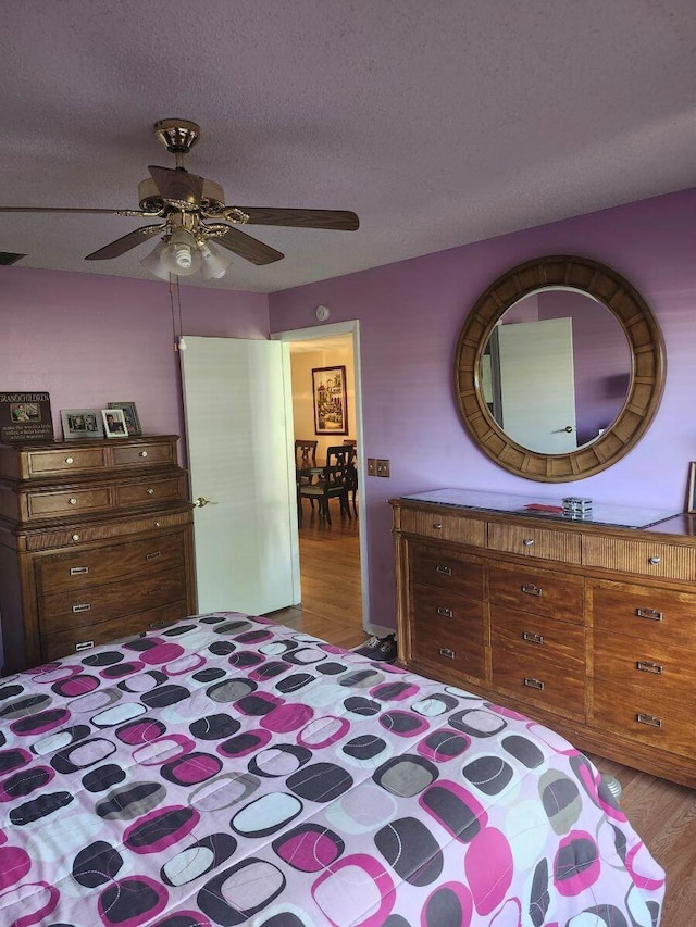 5794 Moss Ct Unit 7, Fort Pierce, FL 34982 - bedroom featuring wood finished floors, a ceiling fan, and a textured ceiling