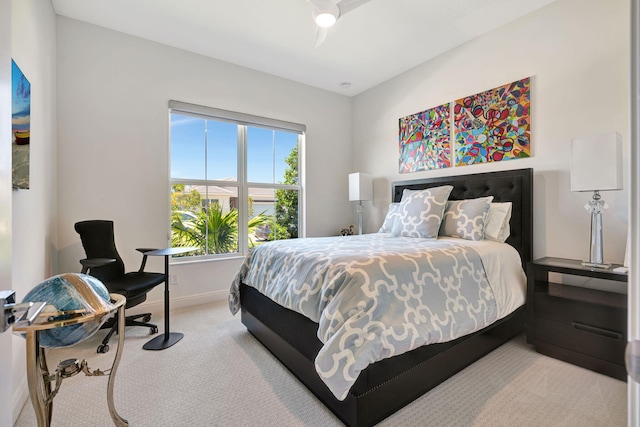 bedroom featuring light carpet and baseboards