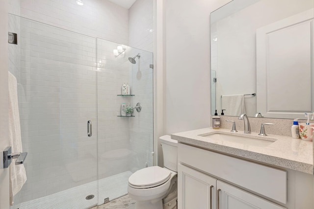 full bathroom with toilet, a stall shower, and vanity