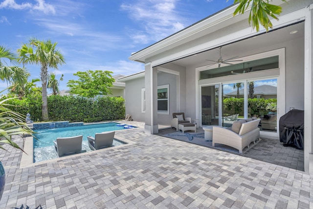 view of swimming pool featuring a ceiling fan, a patio, outdoor lounge area, and grilling area