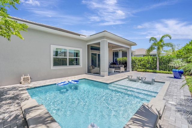 view of swimming pool featuring a patio area, an outdoor hangout area, and a ceiling fan