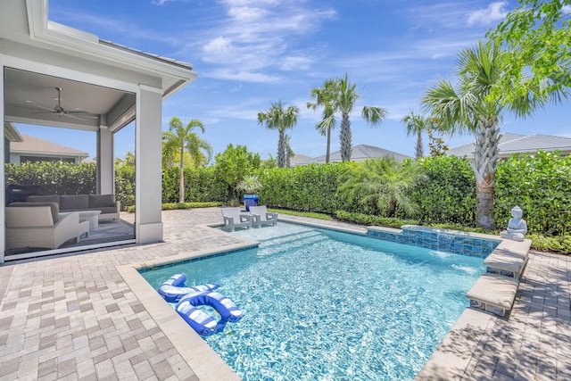 view of swimming pool featuring a patio and a ceiling fan