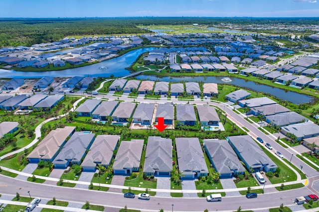 aerial view of property's location featuring nearby suburban area and a nearby body of water