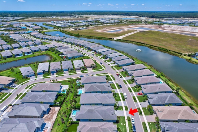 aerial overview of property's location with nearby suburban area and a nearby body of water