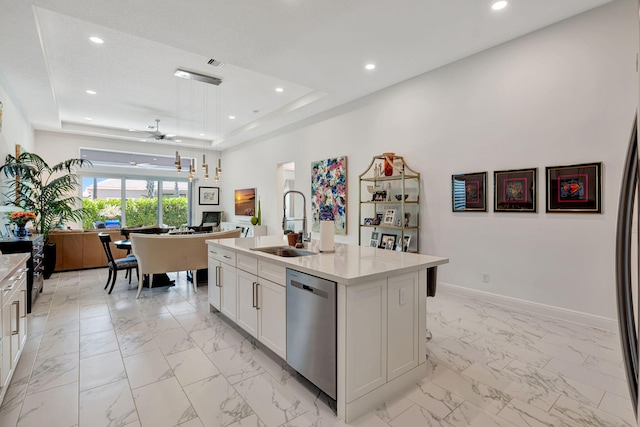 kitchen featuring dishwasher, a sink, light marble finish flooring, a tray ceiling, and recessed lighting
