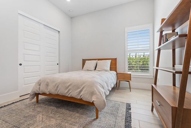 20049 SE Bridgewater Dr, Jupiter, FL 33458 - bedroom with a closet, baseboards, and light wood-type flooring
