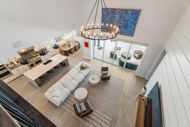 20049 SE Bridgewater Dr, Jupiter, FL 33458 - living room with a high ceiling, a chandelier, and wood finished floors