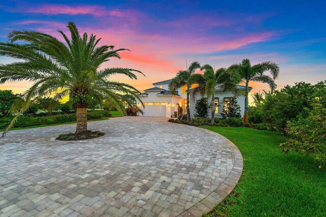 20049 SE Bridgewater Dr, Jupiter, FL 33458 - view of front facade featuring curved driveway, a front yard, and stucco siding