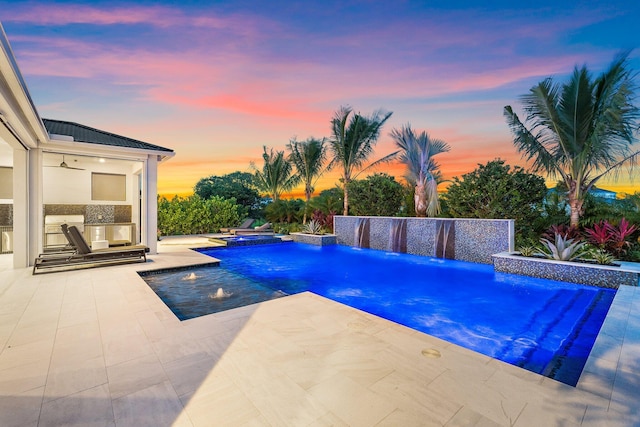 20049 SE Bridgewater Dr, Jupiter, FL 33458 - pool at dusk featuring a jacuzzi, a patio area, area for grilling, and an outdoor pool