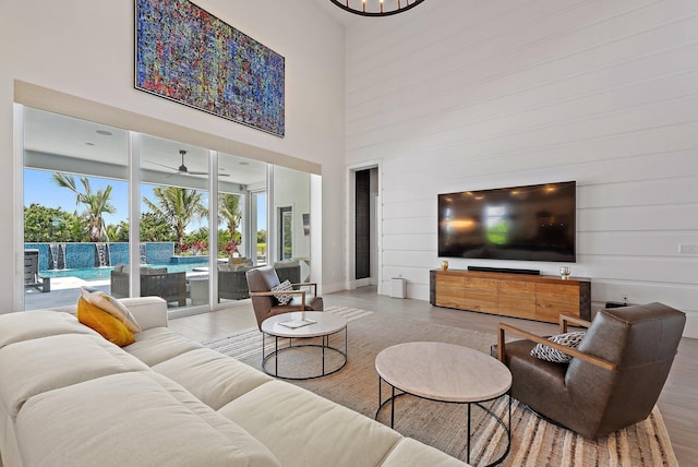 20049 SE Bridgewater Dr, Jupiter, FL 33458 - living area with wood finished floors, healthy amount of natural light, a high ceiling, and a ceiling fan